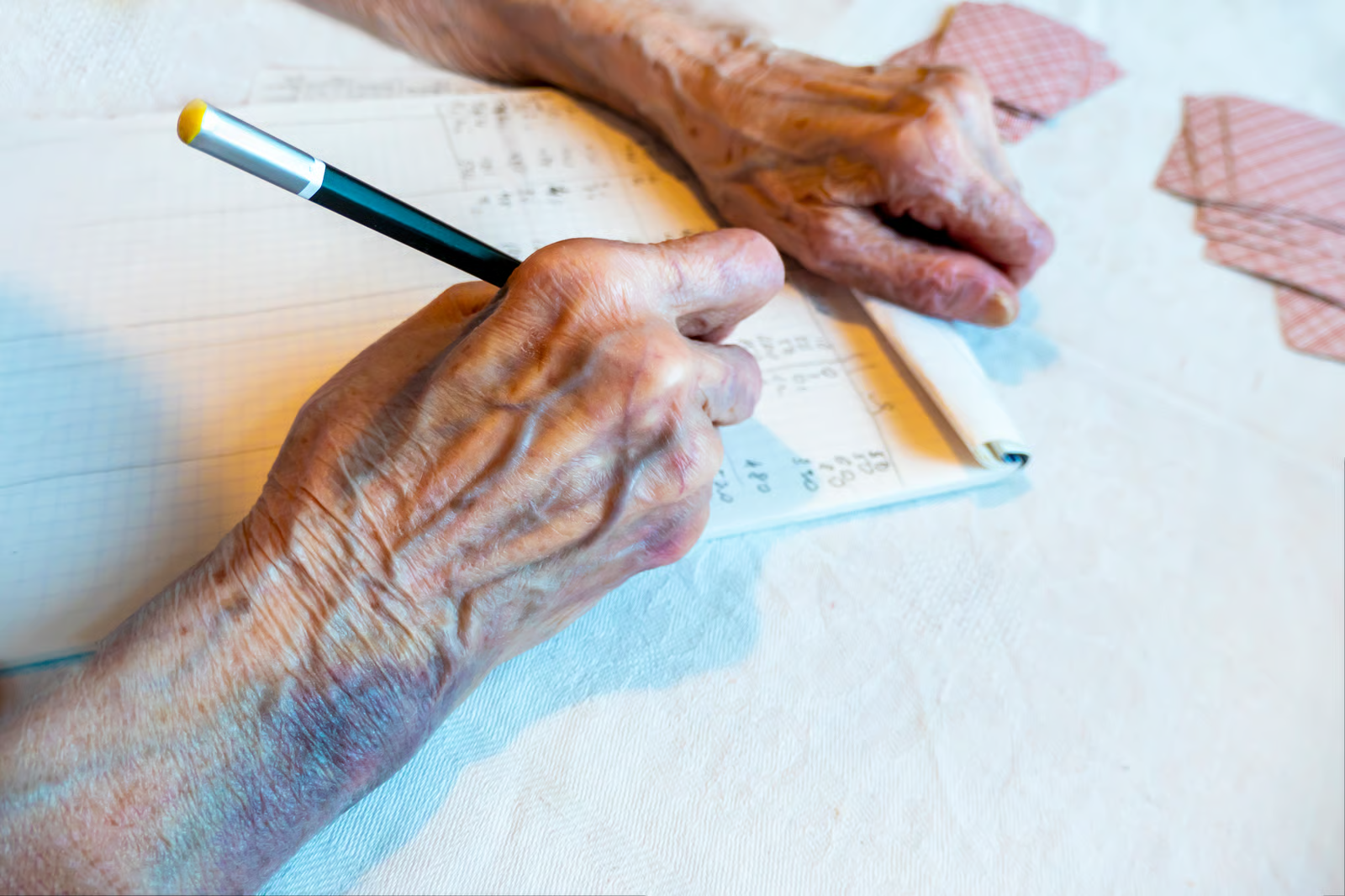 An elderly person signing legal estate planning documents with a pen